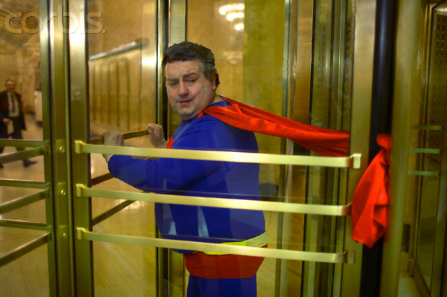 Superhero's cape stuck in revolving door